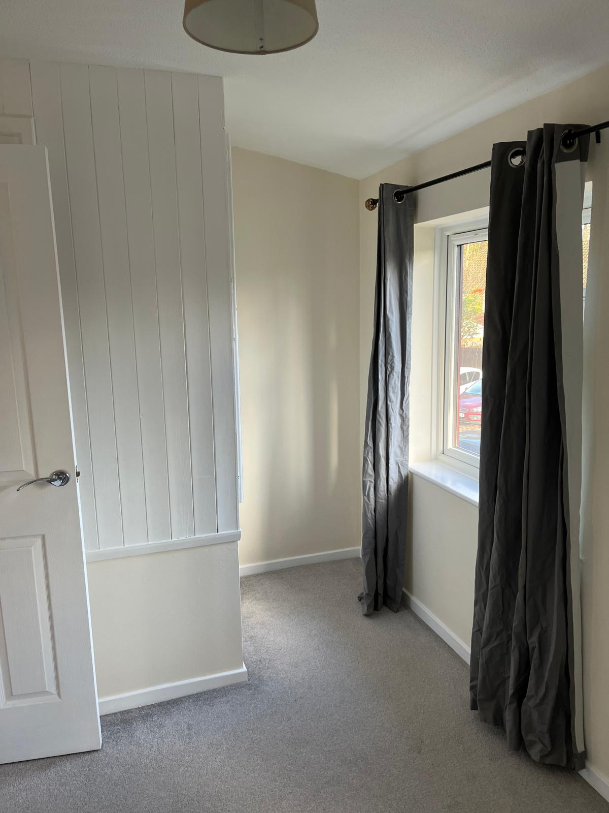 Small bedroom with freshly painted walls and white skirting