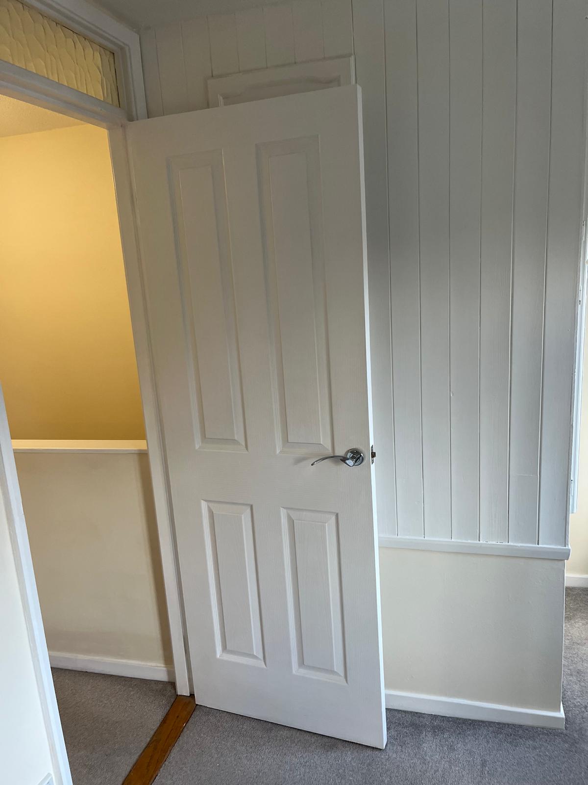 White painted panelling and panelled door