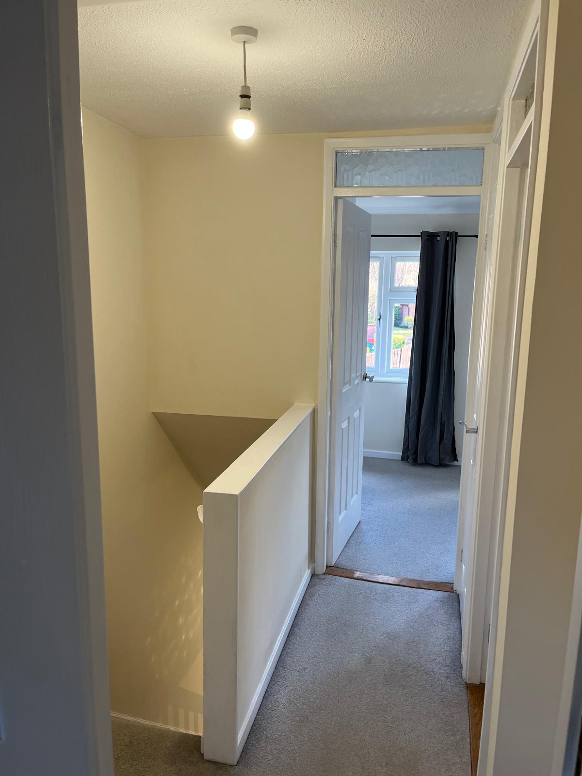 Landing with freshly painted walls, banister wall and door frames