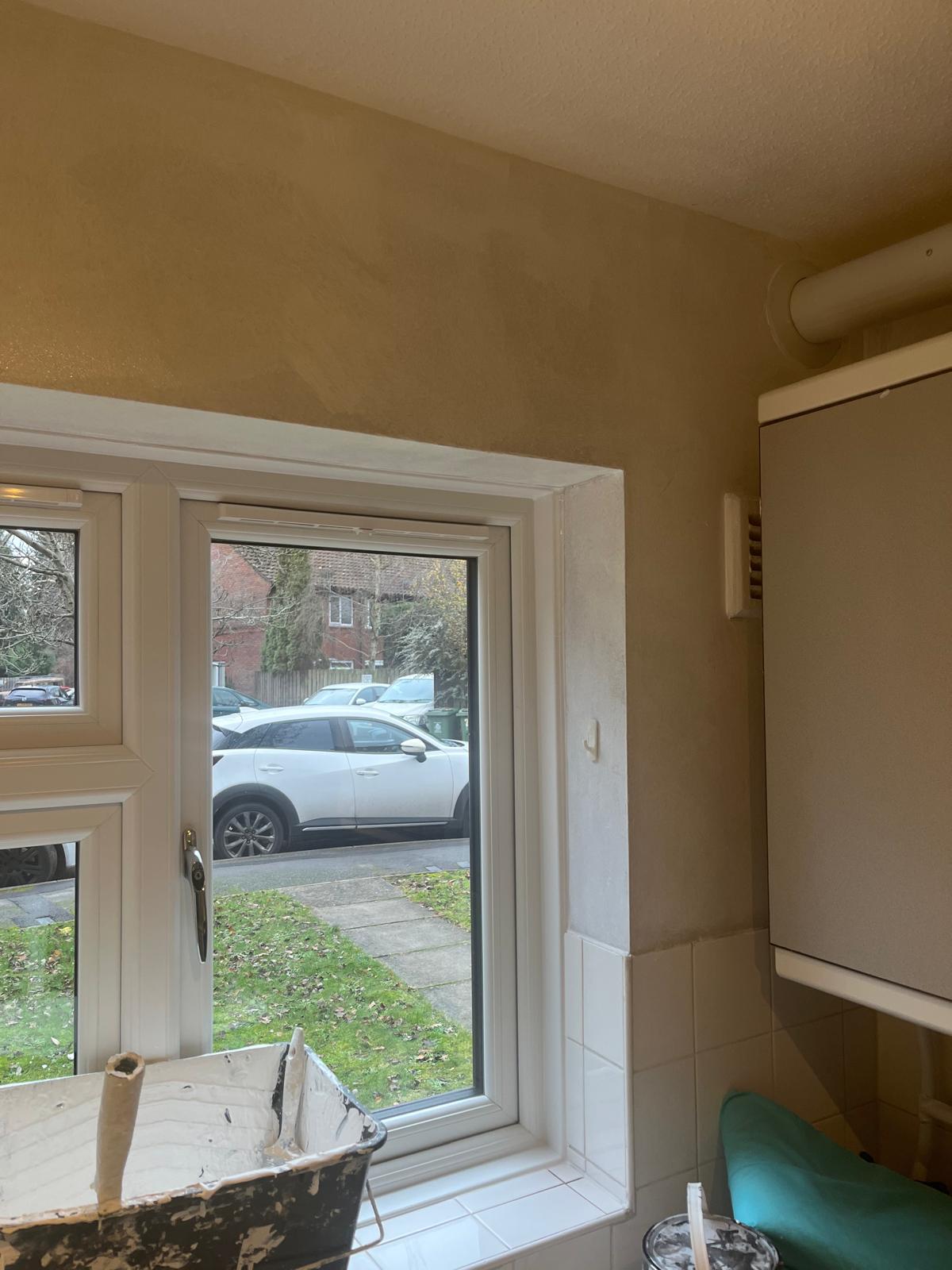 Kitchen wall filled and smoothed around the window before painting