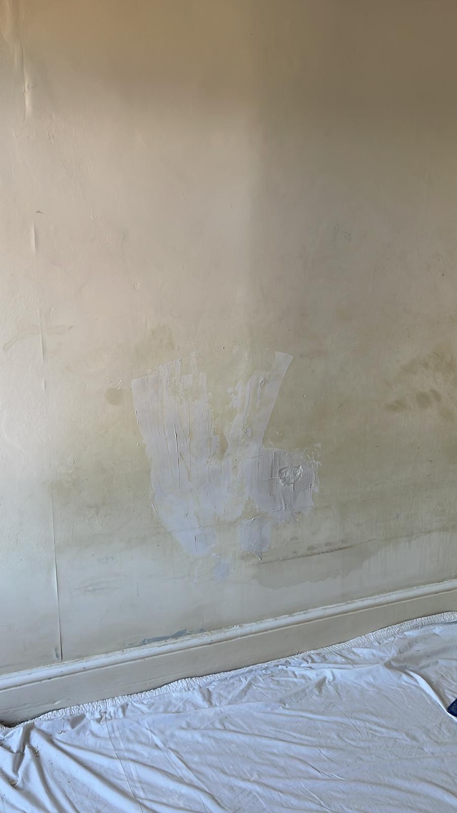 Bedroom wall with filled cracks before painting