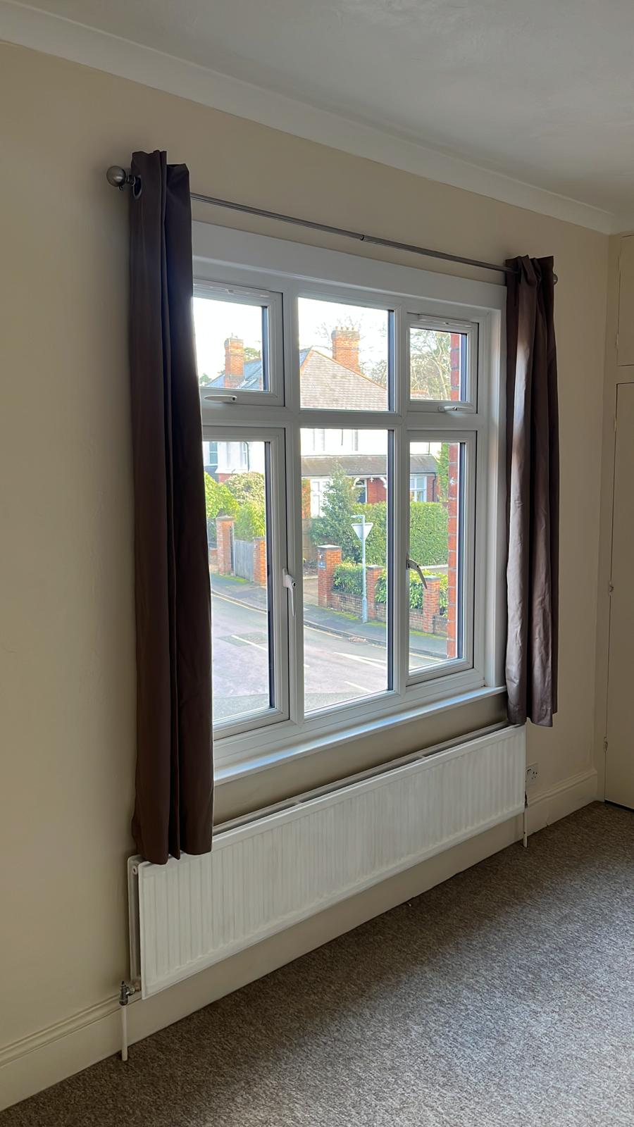 Large bedroom window with freshly painted walls and reveal