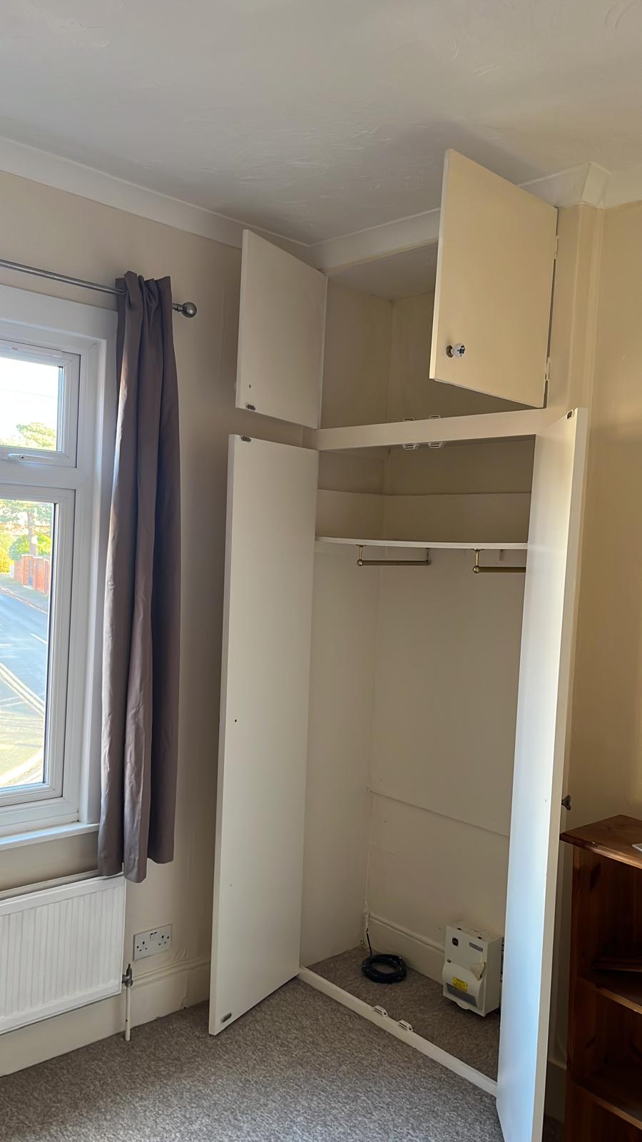 Built-in wardrobe with top cupboards freshly painted