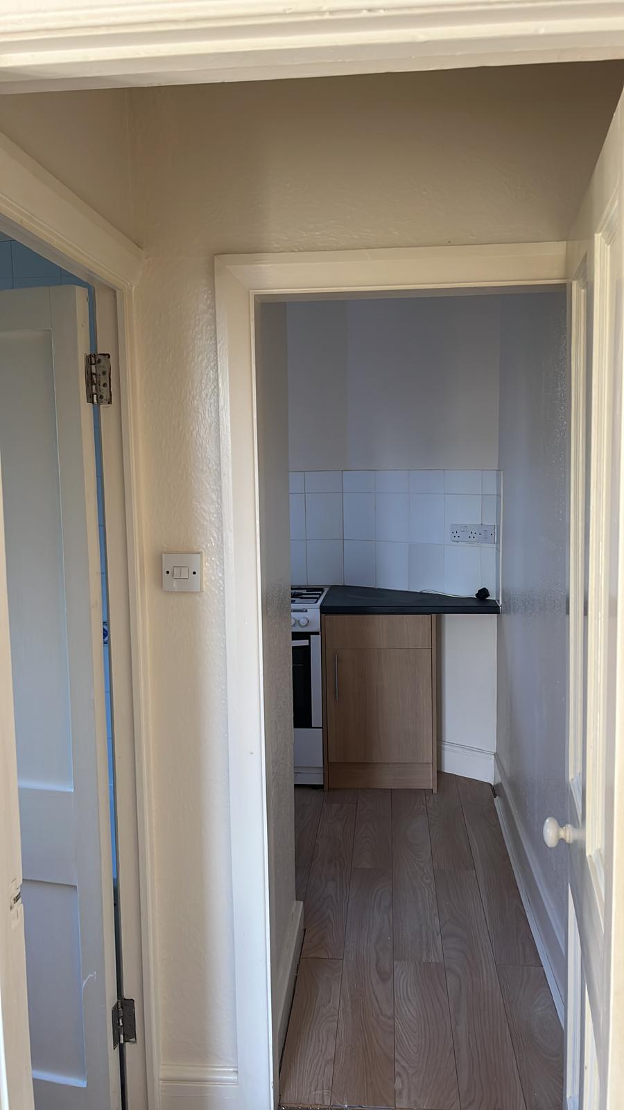 Hallway with freshly painted textured walls and white door frames